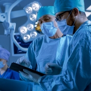 Professional,Surgeons,And,Assistants,Talk,And,Use,Digital,Tablet,Computer